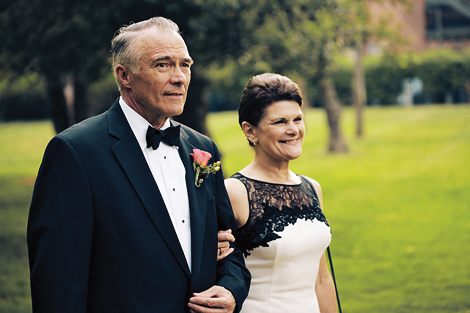The parents of the groom walk down the aisle together at this Aldie Mansion wedding