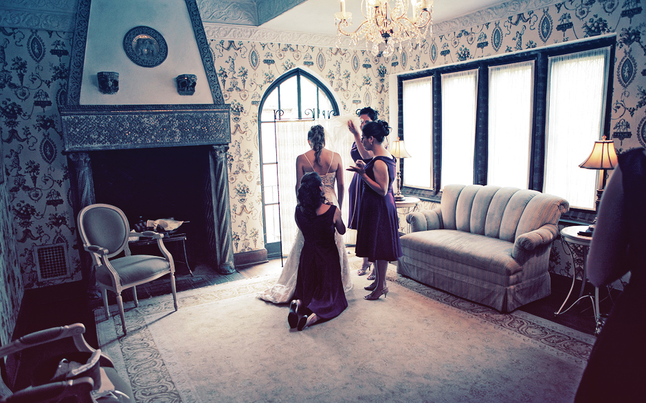 The bride gets ready with her bridesmaids, wearing purple dresses, at the Aldie Mansion, before this Autumn wedding in Pennsylvania