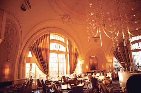 The inside of XIX restaurant in Philadelphia is elegant and sophisticated, with beds hanging from the high ceiling, and large windows letting in lots of warm sunlight