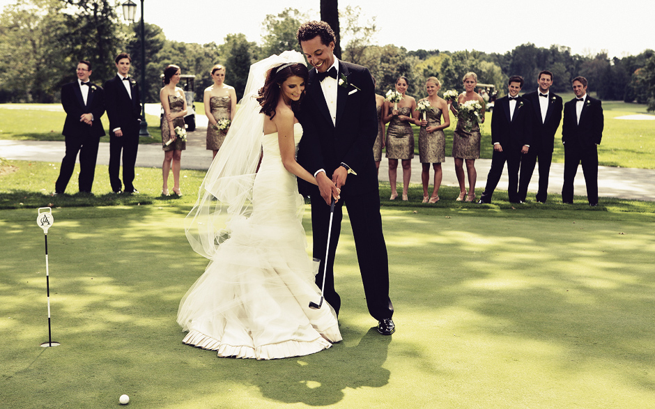 The bride and groom play a round of golf, surrounded by the bridal party before their autumn wedding