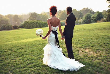 The bride and groom look elegant and sophisticated looking out on the grounds at Greenville Country Club in the sun set