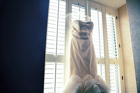 The bride's wedding gown hangs in the window at the Hotel duPont in Delaware