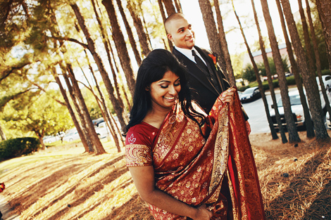 An Indian bride and groom tie the knot in Atlanta, Georgia; they walk through a sunny wooded area before the ceremony