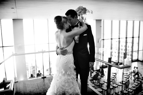 The bride and groom kiss before their reception at the State Room in Boston