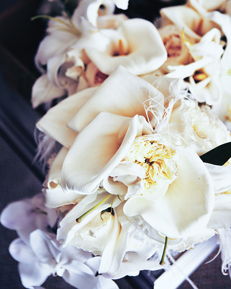 Beautiful white orchids make up this bride's bouquet on her wedding day