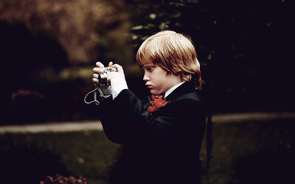 A little boy takes a picture at his parent's wedding in Greenville, Delaware