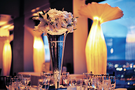 Tall vases filled with flowers stand beautifully against the Boston skyline at the State Room