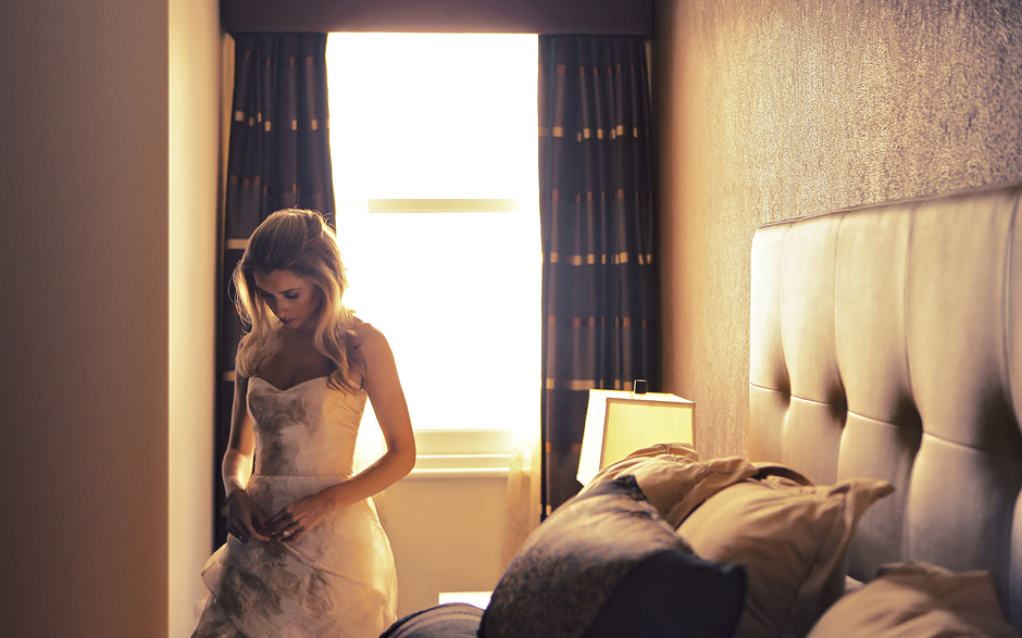 The bride prepares in the late afternoon in her hotel room before their Philadelphia wedding