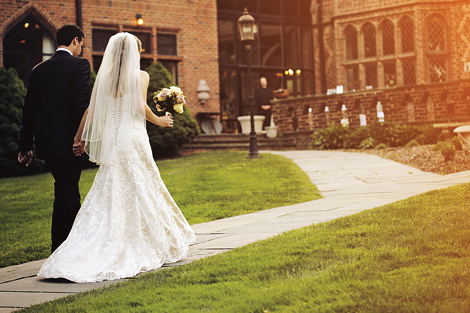 The bride and groom hold hands as they leave their fall ceremony at the Aldie Mansion in Pennsylvania