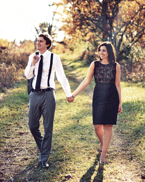 A couple walks, holding hands, through the beautiful fall scenery at the Tyler Arboretum