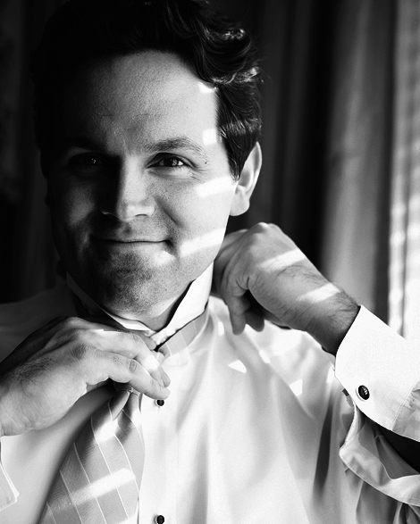 A black and white photo of the groom getting ready before his Los Angeles wedding