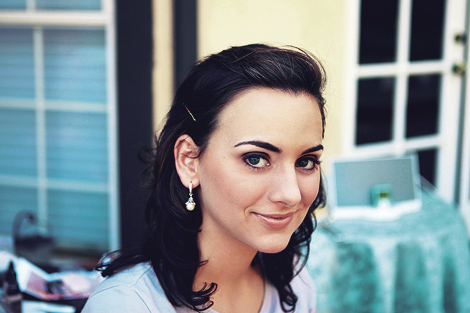 A guest gives a mischevious smile as she gets ready for this Los Angeles wedding