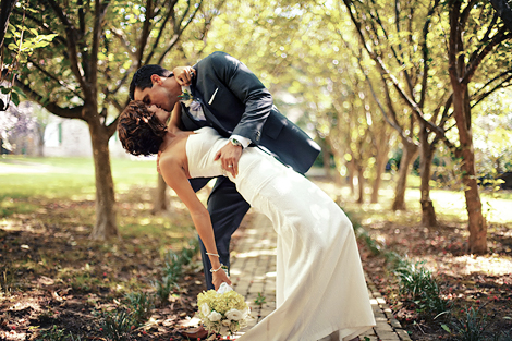 The groom dips the bride, kissing her in this classically beautiful pose on a warm late summer day at Appleford Estate in Villanova, PA, wedding photographer Peter Van Beever