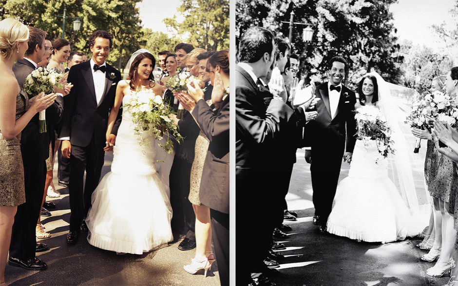 The bride and groom walk through their bridal party, as they clap in celebration