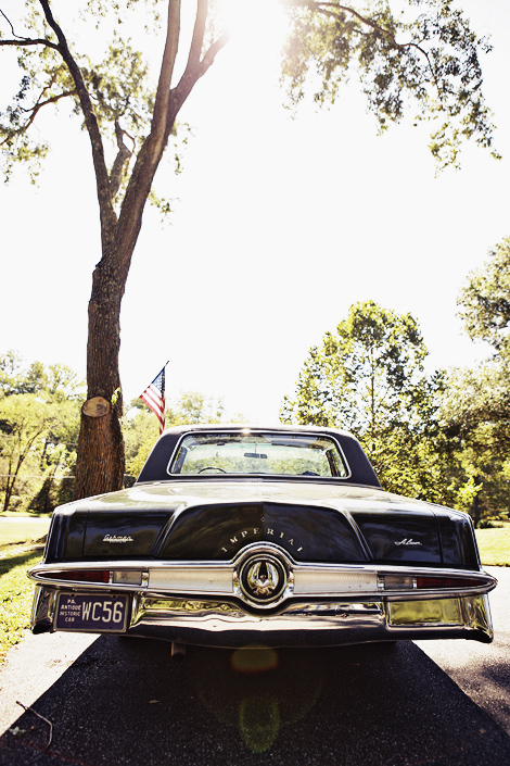 An Imperial vintage car transports the bride and groom on their wedding day