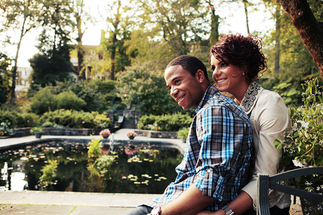 The bride and groom sit together by the lily covered pond at Winterthur in Delaware