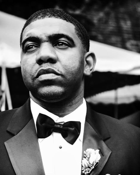 A groomsman looks out at Greenville Country Club