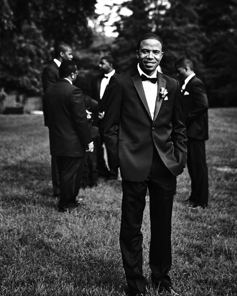 The groom poses for a portrait