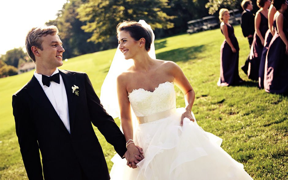 The bride and groom hold hands on the golf course at the Moorestown Field Club