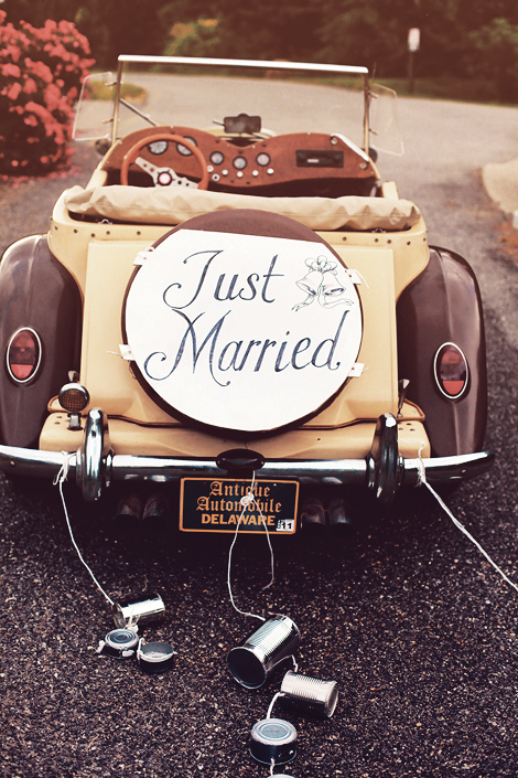 Antique brown car with a just married sign with tin cans from antique automotive in delaware.