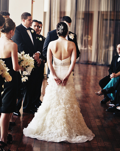 The bride and groom say their vows at the State Room in Boston