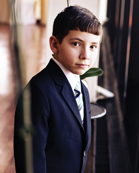 A young boy looks out the windows at the State Room Boston