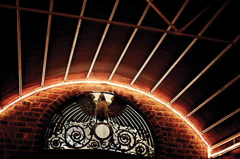 An elegant carving hangs above the doorway at this wedding reception