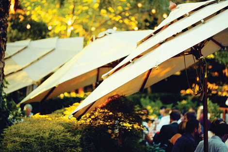 Umbrellas line the path to the wedding, giving it a resort feel